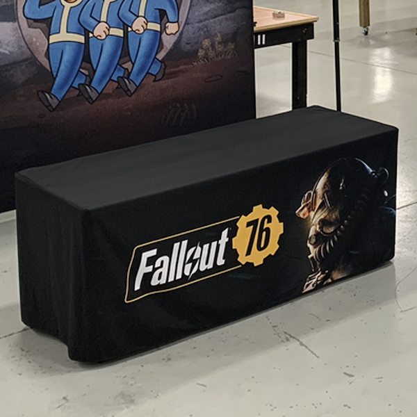 A black table cover with logo printed on front.